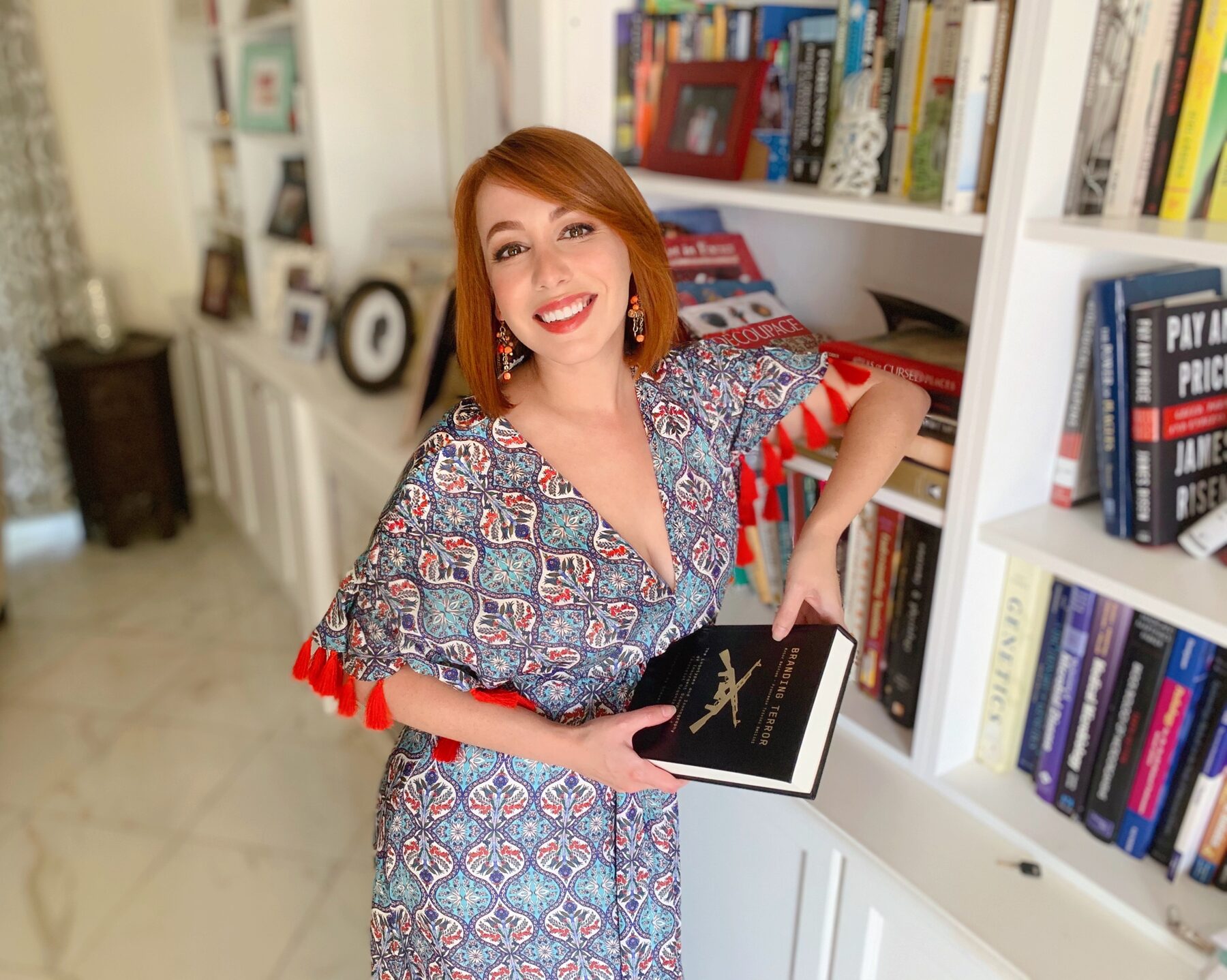 Gisselle Legere at home among her bookshelves